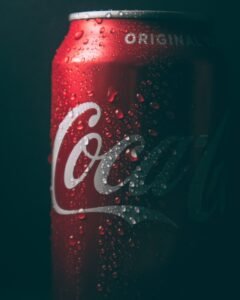 dimly lit coca-cola can with water sweat beads