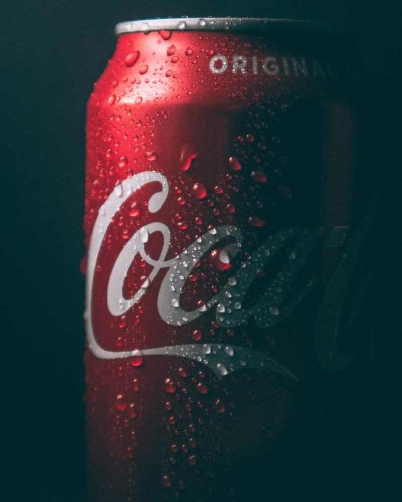 dimly lit coca-cola can with water sweat beads