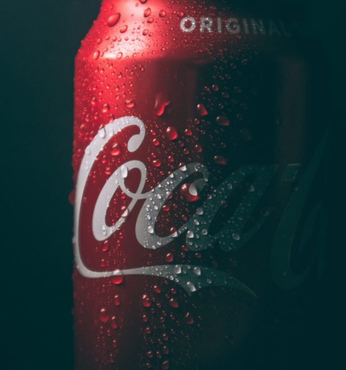 dimly lit coca-cola can with water sweat beads