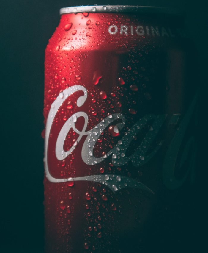 dimly lit coca-cola can with water sweat beads